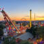 a group of roller coasters and a ferris wheel