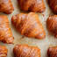 a group of croissants on a baking sheet