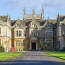 a large stone building with a lawn