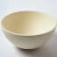 a white bowl on a white surface