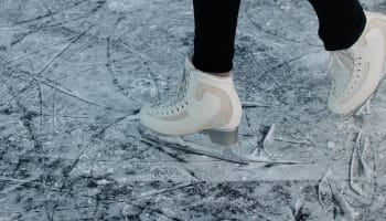 a person's feet in ice skates