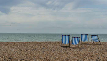 a group of chairs on a beach