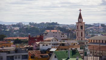a group of buildings with a church tower