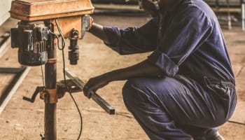 a person in a hard hat working on a machine