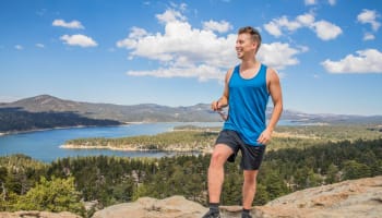 a person standing on a rock looking over a lake