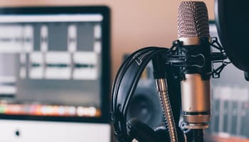 a microphone and headphones in front of a monitor