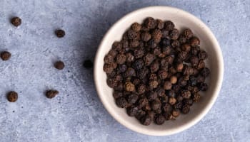 a bowl of black peppercorns