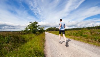 a person running on a dirt road