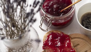 a jar of jam and a piece of bread