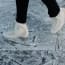 a person's feet in ice skates