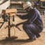 a person in a hard hat working on a machine