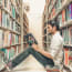 a person sitting in a library reading a book