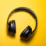 a pair of black headphones on a yellow background