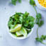 a bowl of cilantro and limes