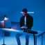 a person sitting at a desk with a laptop