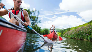 a group of people paddling a canoe