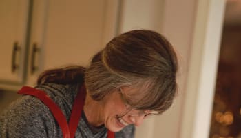 a baby and a person making dough