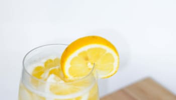 a lemon cut in half on a wooden surface