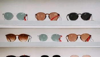 a group of sunglasses on shelves