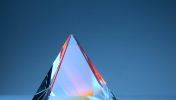 a glass pyramid on a blue background