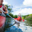 a group of people paddling a canoe