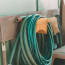 a green hose on a yellow holder