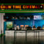 a movie theater with a sign above it