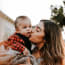 a person kissing a baby