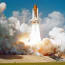 a space shuttle taking off from a launch pad