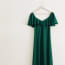 a green dress on a hanger