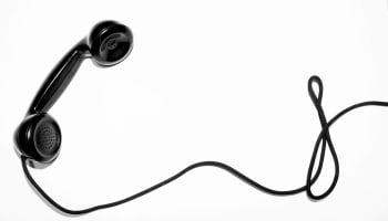 a black phone with a wire