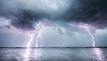 lightning striking the sky over water