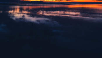 a sunset over a beach
