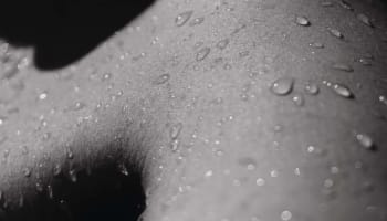a close up of water droplets on a person's skin