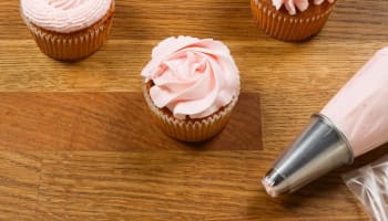 a group of cupcakes with pink frosting