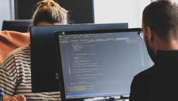 a group of people working on a computer