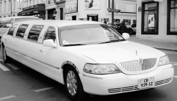 a white limo parked on a street