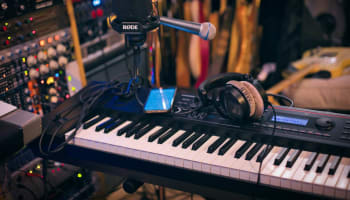 a microphone and headphones on a piano