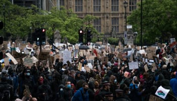 a group of people holding signs in the street