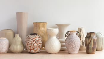 a group of vases on a shelf