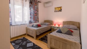 a room with two beds and a window