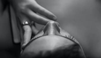 a person's face with a hand on the nose