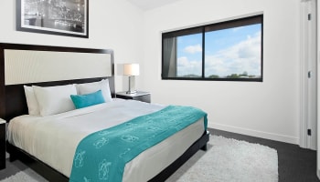 a bedroom with a bed and a window