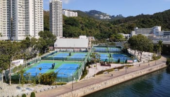 tennis courts by a body of water