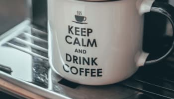 a white mug with a brown liquid in it