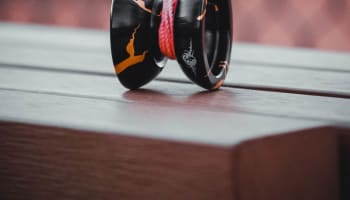 a black and orange yoyo on a wood surface