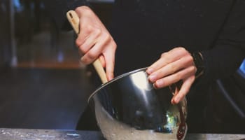 a person mixing food in a bowl