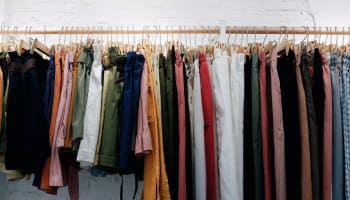 a row of pants on hangers