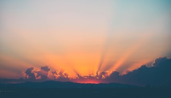 sun rays of light shining through clouds