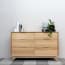 a wooden dresser with a plant on top